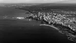 Urban Serenity: A Black and White Aerial View of the Cityscape by the Water