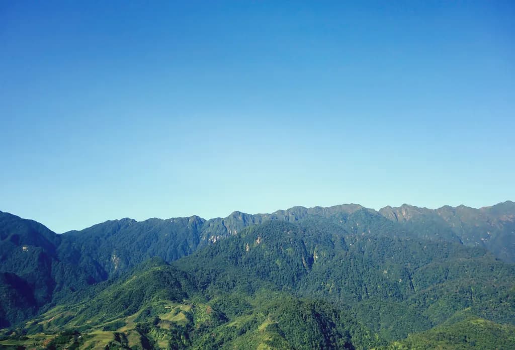 Whispers of Serenity: A Majestic Mountain Landscape Beneath a Clear Blue Sky